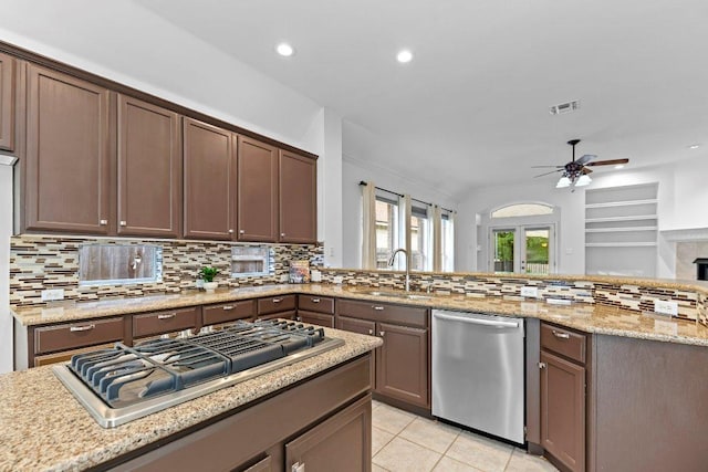 13121 Armaga Springs Rd, Austin, TX 78727 - kitchen featuring appliances with stainless steel finishes, a ceiling fan, backsplash, recessed lighting, and light tile patterned floors