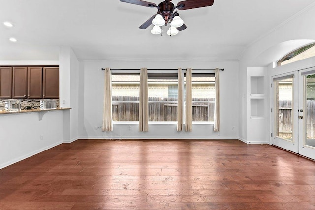 13121 Armaga Springs Rd, Austin, TX 78727 - unfurnished living room featuring crown molding, ceiling fan, dark wood-style flooring, and french doors