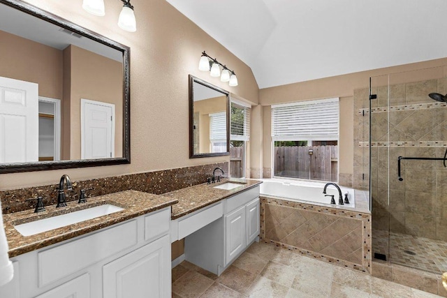 13121 Armaga Springs Rd, Austin, TX 78727 - bathroom with double vanity, a stall shower, lofted ceiling, and a garden tub