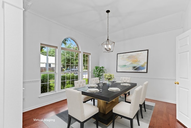 13121 Armaga Springs Rd, Austin, TX 78727 - dining space with crown molding, dark wood-type flooring, and a chandelier