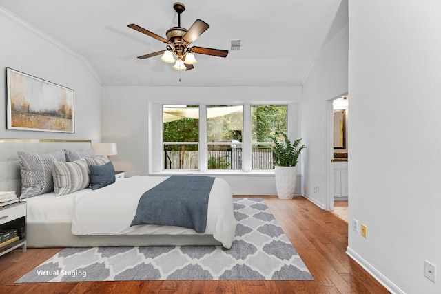 13121 Armaga Springs Rd, Austin, TX 78727 - bedroom featuring crown molding, lofted ceiling, wood finished floors, ensuite bath, and a ceiling fan