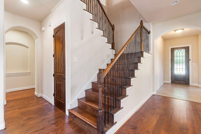 2713 Windy Vane Dr, Pflugerville, TX 78660 - foyer entrance featuring arched walkways, wood finished floors, stairs, and recessed lighting