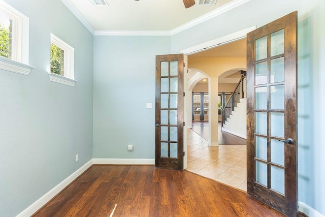 2713 Windy Vane Dr, Pflugerville, TX 78660 - spare room with french doors, arched walkways, ornamental molding, wood finished floors, and a ceiling fan