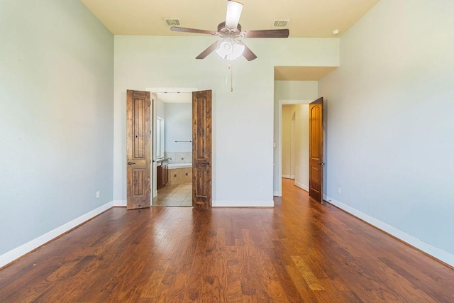 2713 Windy Vane Dr, Pflugerville, TX 78660 - unfurnished bedroom featuring wood finished floors, connected bathroom, and ceiling fan