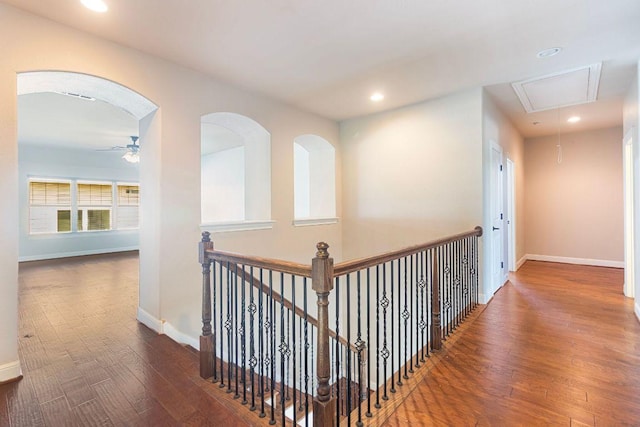 2713 Windy Vane Dr, Pflugerville, TX 78660 - corridor featuring attic access, wood finished floors, recessed lighting, arched walkways, and an upstairs landing