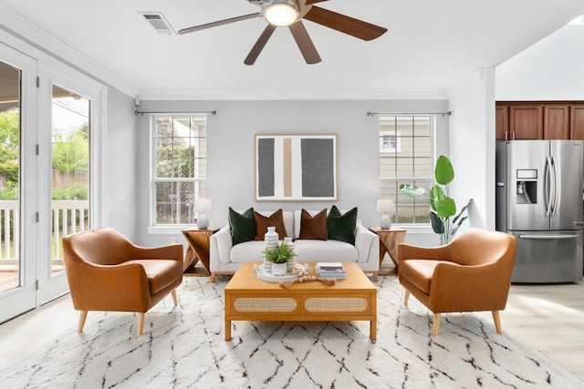 6715 Windrift Way Unit 29, Austin, TX 78745 - living room featuring ornamental molding, ceiling fan, and light wood-style floors