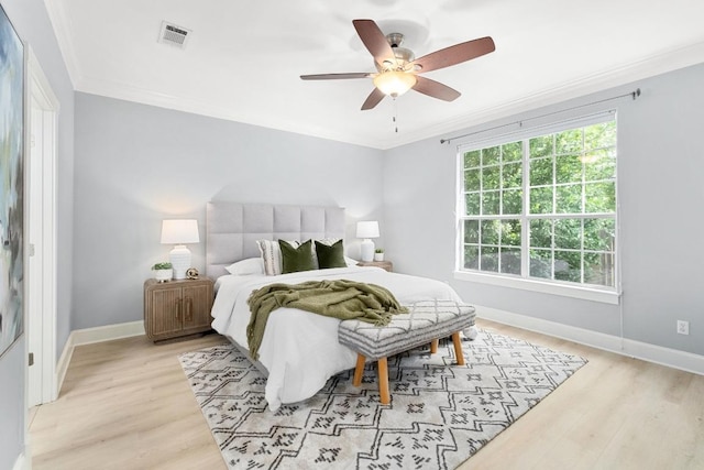 6715 Windrift Way Unit 29, Austin, TX 78745 - bedroom with crown molding, light wood-style flooring, and a ceiling fan