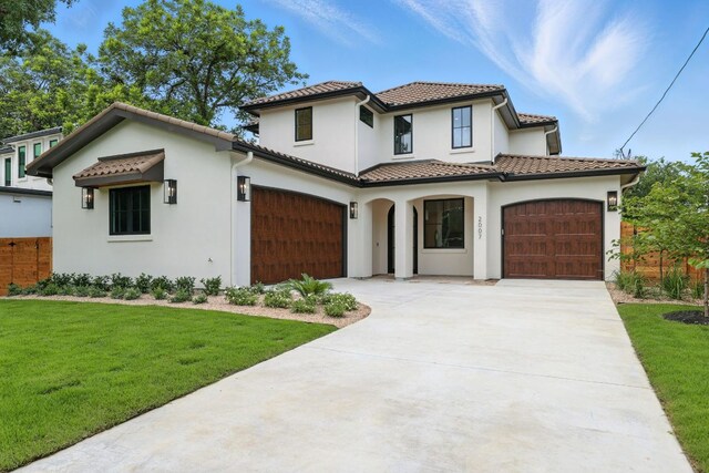 2007 Pasadena Dr, Austin, TX 78757 - mediterranean / spanish-style home with an attached garage, driveway, stucco siding, and a tile roof