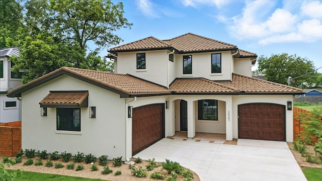 2007 Pasadena Dr, Austin, TX 78757 - mediterranean / spanish house featuring a tiled roof, driveway, stucco siding, and an attached garage