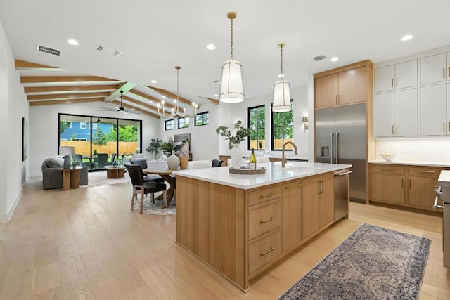 2007 Pasadena Dr, Austin, TX 78757 - kitchen with stainless steel appliances, open floor plan, light wood-style flooring, light countertops, and recessed lighting