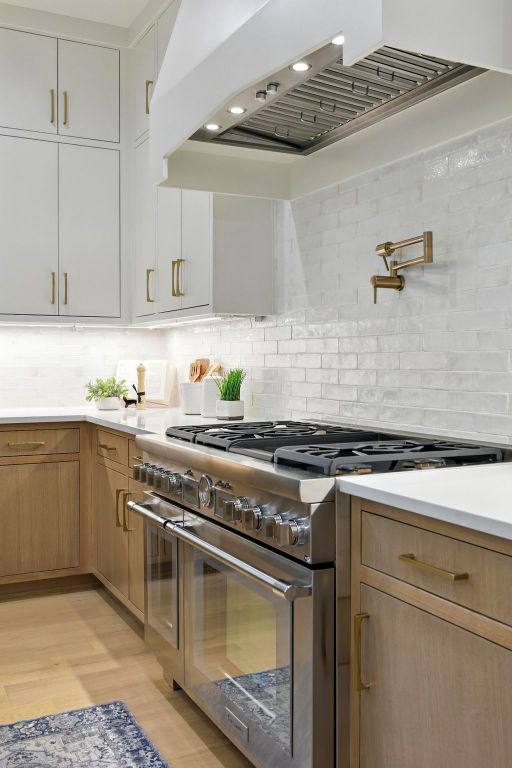 2007 Pasadena Dr, Austin, TX 78757 - kitchen with double oven range, custom exhaust hood, light countertops, backsplash, and light wood-style floors