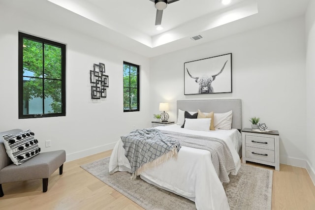 2007 Pasadena Dr, Austin, TX 78757 - bedroom featuring a raised ceiling, light wood-style floors, recessed lighting, and ceiling fan