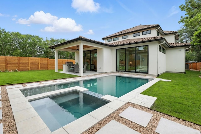2007 Pasadena Dr, Austin, TX 78757 - rear view of house featuring a pool with connected hot tub, a patio, stucco siding, ceiling fan, and a fenced backyard