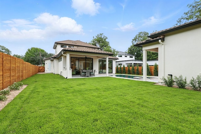2007 Pasadena Dr, Austin, TX 78757 - rear view of house with a fenced backyard, stucco siding, a patio area, and a tiled roof