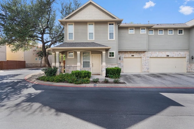11000 Anderson Mill Rd Unit 52, Austin, TX 78750 - craftsman house with driveway, stone siding, a garage, and a porch