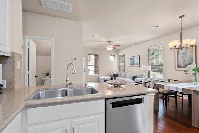 11000 Anderson Mill Rd Unit 52, Austin, TX 78750 - kitchen featuring stainless steel dishwasher, plenty of natural light, dark wood finished floors, and white cabinets