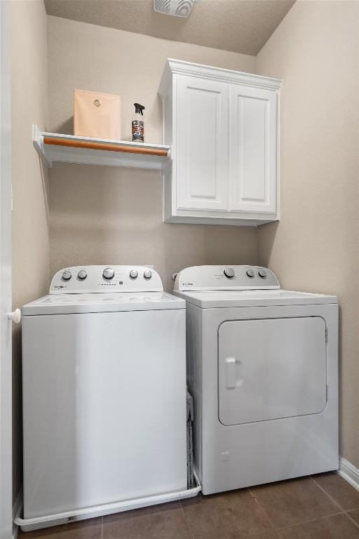 11000 Anderson Mill Rd Unit 52, Austin, TX 78750 - washroom with independent washer and dryer, cabinet space, and tile patterned floors
