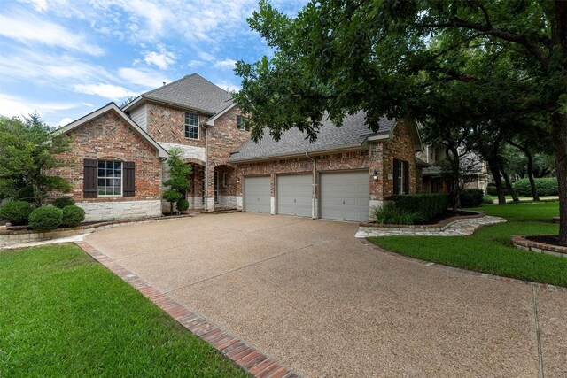 1343 River Forest Dr, Round Rock, TX 78665 - traditional home with driveway, brick siding, a shingled roof, and a front lawn