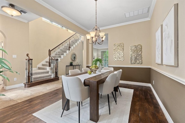 1343 River Forest Dr, Round Rock, TX 78665 - dining room with stairs, ornamental molding, a chandelier, wood-type flooring, and arched walkways