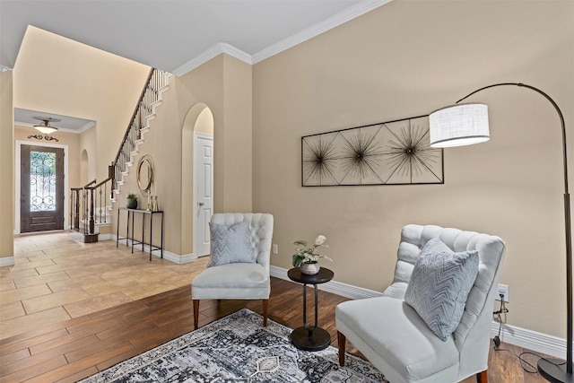1343 River Forest Dr, Round Rock, TX 78665 - living area with arched walkways, ornamental molding, wood finished floors, and stairs