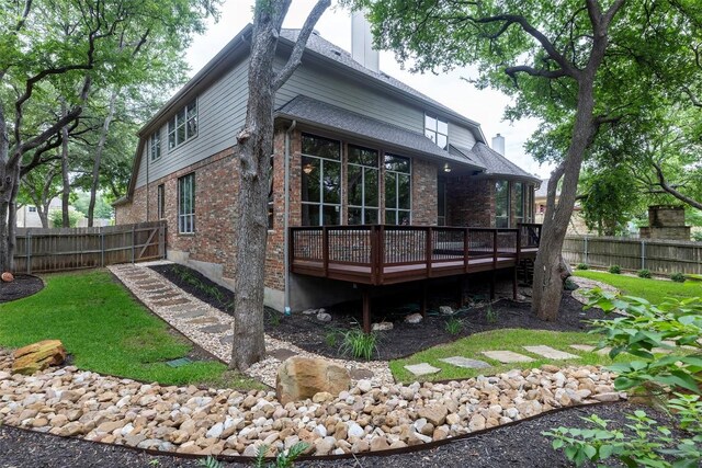 1343 River Forest Dr, Round Rock, TX 78665 - rear view of house with brick siding, a deck, and a fenced backyard