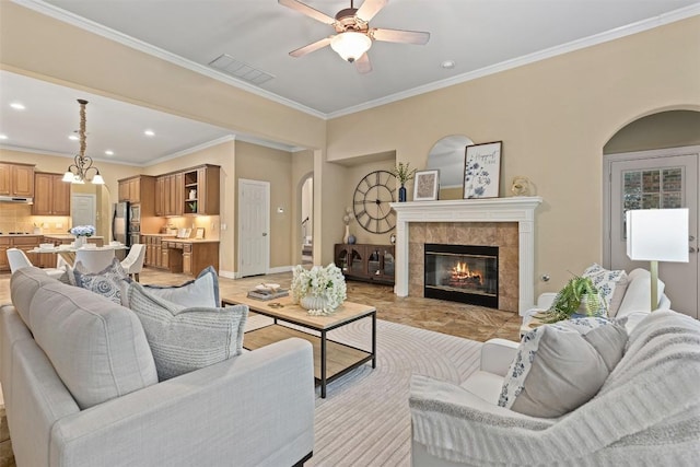 1343 River Forest Dr, Round Rock, TX 78665 - living area with arched walkways, ceiling fan, crown molding, recessed lighting, and a tiled fireplace