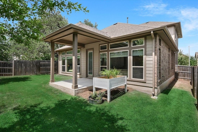 9516 Hunter Ln, Austin, TX 78748 - rear view of property featuring a fenced backyard, a patio area, and a shingled roof