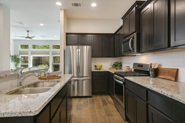 9516 Hunter Ln, Austin, TX 78748 - kitchen with stainless steel appliances, ceiling fan, light stone countertops, recessed lighting, and backsplash