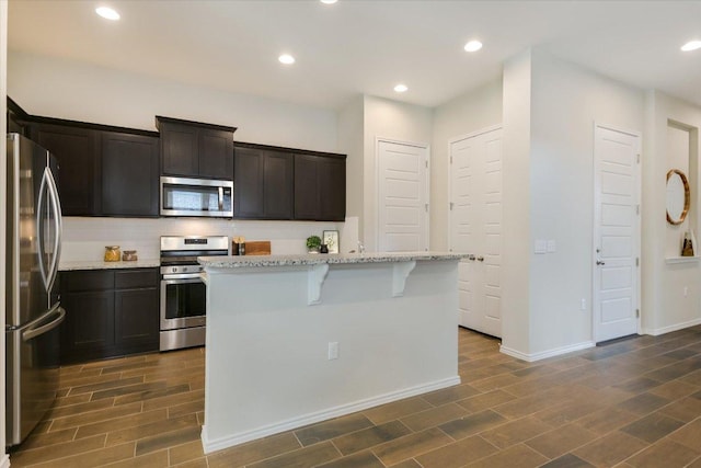 9516 Hunter Ln, Austin, TX 78748 - kitchen featuring appliances with stainless steel finishes, light stone counters, dark wood-style floors, decorative backsplash, and recessed lighting