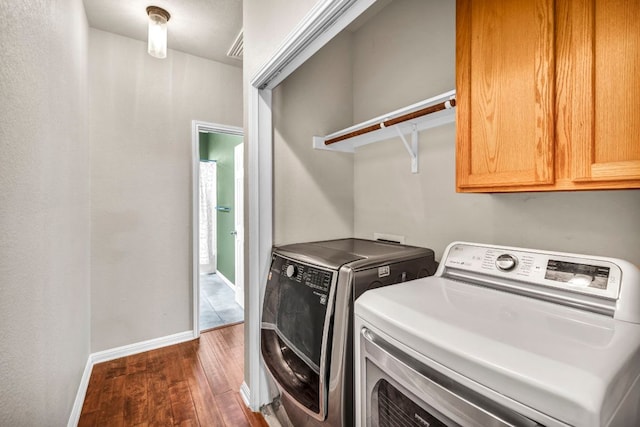 8518 Cahill Dr Unit 23, Austin, TX 78729 - laundry room with cabinet space, dark wood-style flooring, and independent washer and dryer