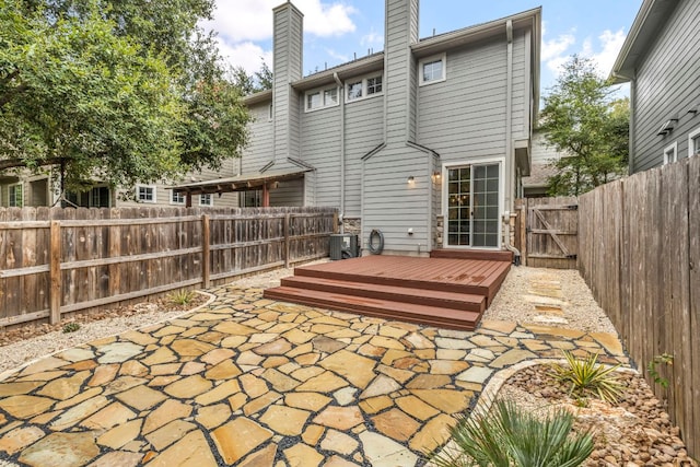 8518 Cahill Dr Unit 23, Austin, TX 78729 - back of property featuring a patio, a chimney, a fenced backyard, and a deck