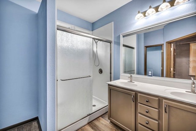 8518 Cahill Dr Unit 23, Austin, TX 78729 - full bath with a stall shower, double vanity, and wood finished floors