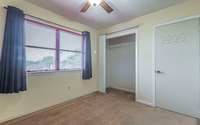 5605 China Berry Rd, Austin, TX 78744 - unfurnished bedroom with carpet flooring, a textured ceiling, ceiling fan, and a closet