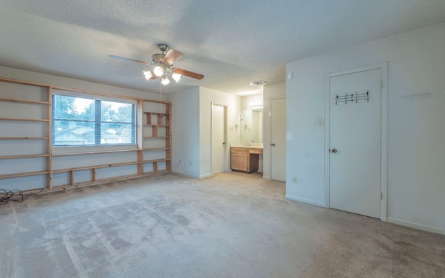 5605 China Berry Rd, Austin, TX 78744 - unfurnished bedroom with carpet flooring, a textured ceiling, ensuite bathroom, and a ceiling fan