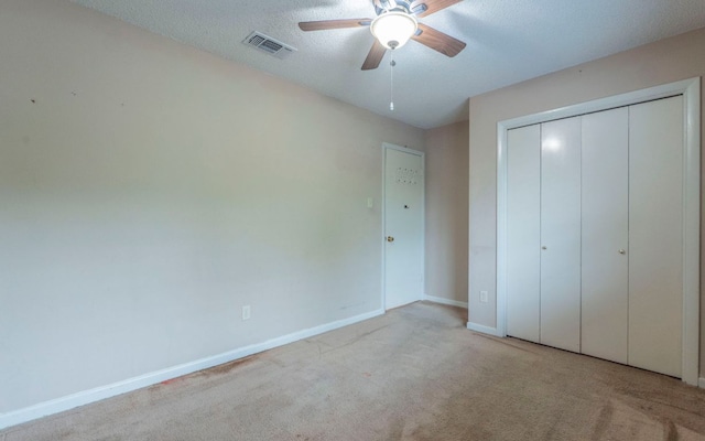5605 China Berry Rd, Austin, TX 78744 - unfurnished bedroom featuring carpet flooring, a closet, and a ceiling fan