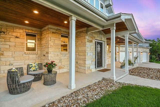 3009 Lawrence Dr, Austin, TX 78734 - patio terrace at dusk with covered porch, driveway, and an attached garage