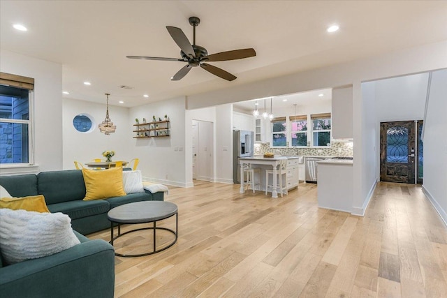 3009 Lawrence Dr, Austin, TX 78734 - living room featuring light wood finished floors, recessed lighting, ceiling fan, and a chandelier