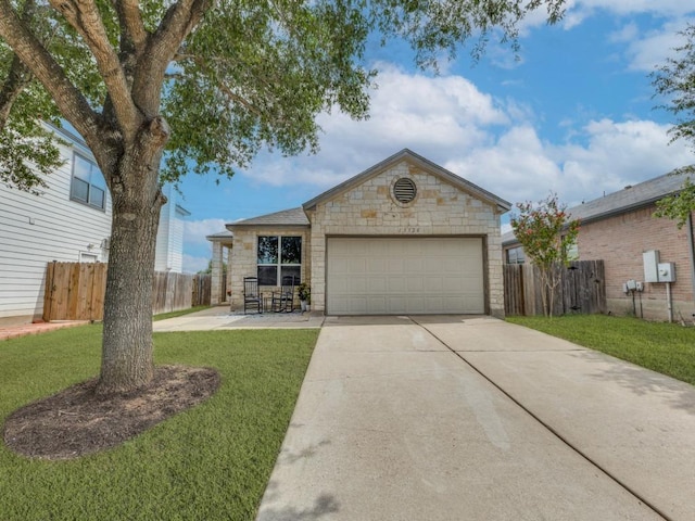 13320 Gilwell Dr, Del Valle, TX 78617 - view of front of property with stone siding, driveway, and a garage