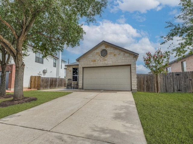 13320 Gilwell Dr, Del Valle, TX 78617 - view of front facade featuring stone siding, concrete driveway, and an outbuilding