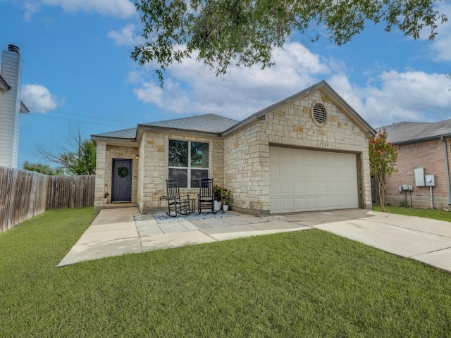 13320 Gilwell Dr, Del Valle, TX 78617 - view of front of property with an attached garage, concrete driveway, and stone siding