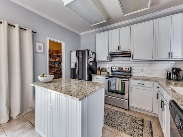 13320 Gilwell Dr, Del Valle, TX 78617 - kitchen featuring stainless steel appliances, ornamental molding, a kitchen island, under cabinet range hood, and light tile patterned floors