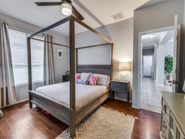 13320 Gilwell Dr, Del Valle, TX 78617 - bedroom with multiple windows, dark wood-style flooring, and ceiling fan
