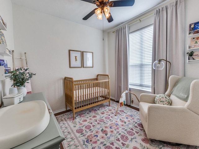 13320 Gilwell Dr, Del Valle, TX 78617 - bedroom featuring multiple windows, a crib, and a ceiling fan