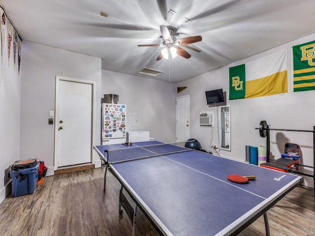 13320 Gilwell Dr, Del Valle, TX 78617 - playroom with wood finished floors, ceiling fan, and a wall mounted air conditioner