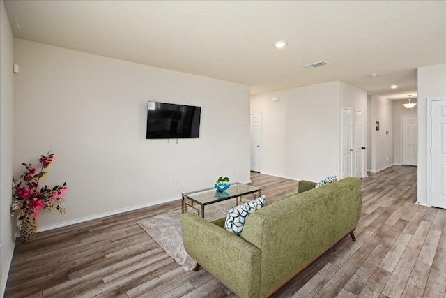 212 Gunther Way, Taylor, TX 76574 - living room featuring wood finished floors and recessed lighting