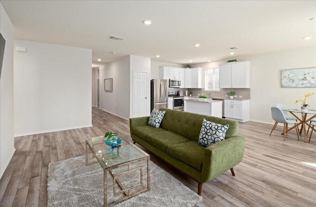 212 Gunther Way, Taylor, TX 76574 - living room with light wood-style flooring and recessed lighting