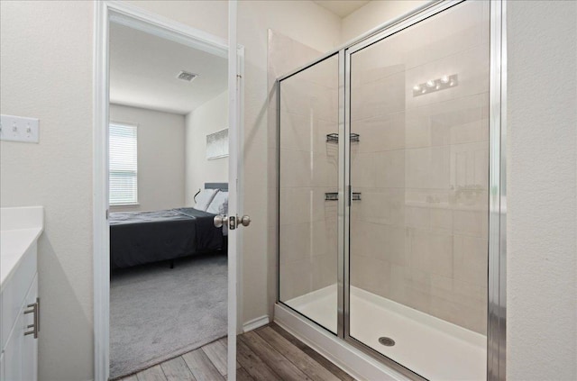 212 Gunther Way, Taylor, TX 76574 - ensuite bathroom with wood finished floors, a stall shower, and vanity