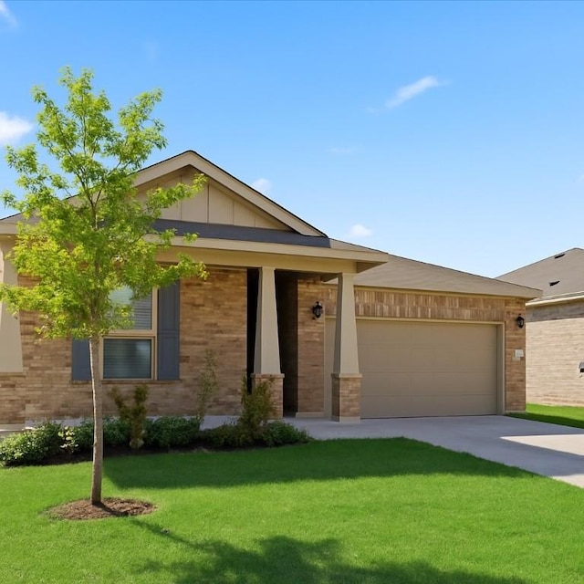 212 Gunther Way, Taylor, TX 76574 - view of front of property featuring a front lawn, driveway, an attached garage, board and batten siding, and brick siding