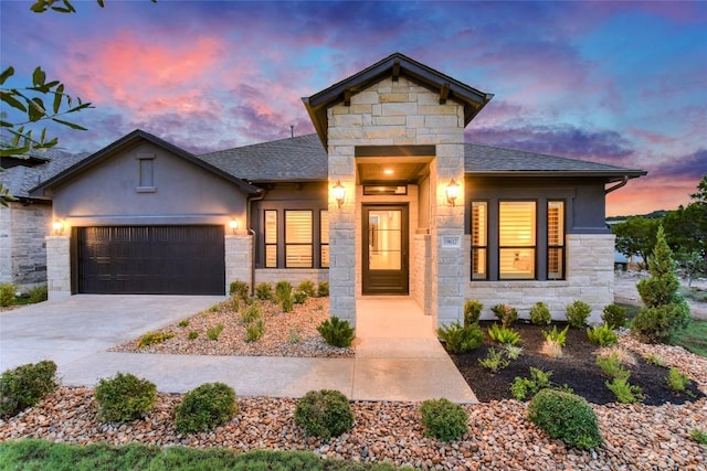 19617 Serenity Ln, Lago Vista, TX 78645 - view of front of house with stone siding, concrete driveway, a garage, stucco siding, and roof with shingles