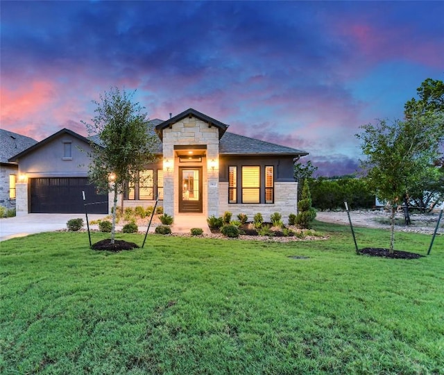 19617 Serenity Ln, Lago Vista, TX 78645 - view of front of home with stone siding, a lawn, concrete driveway, an attached garage, and stucco siding